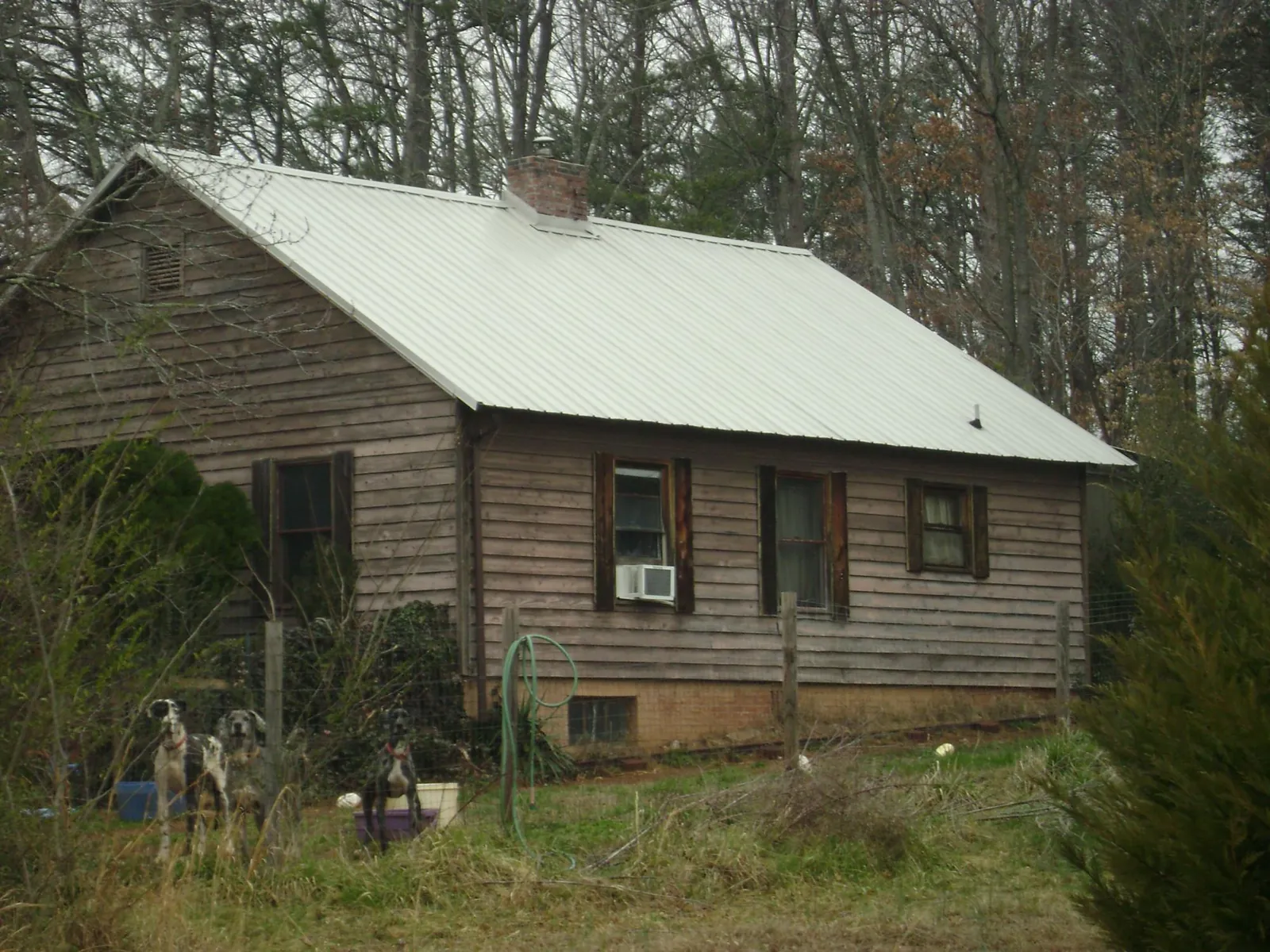 White metal roof on an old wood sided farmhouse, from a Metal Roof Installation job in Rutherfordton